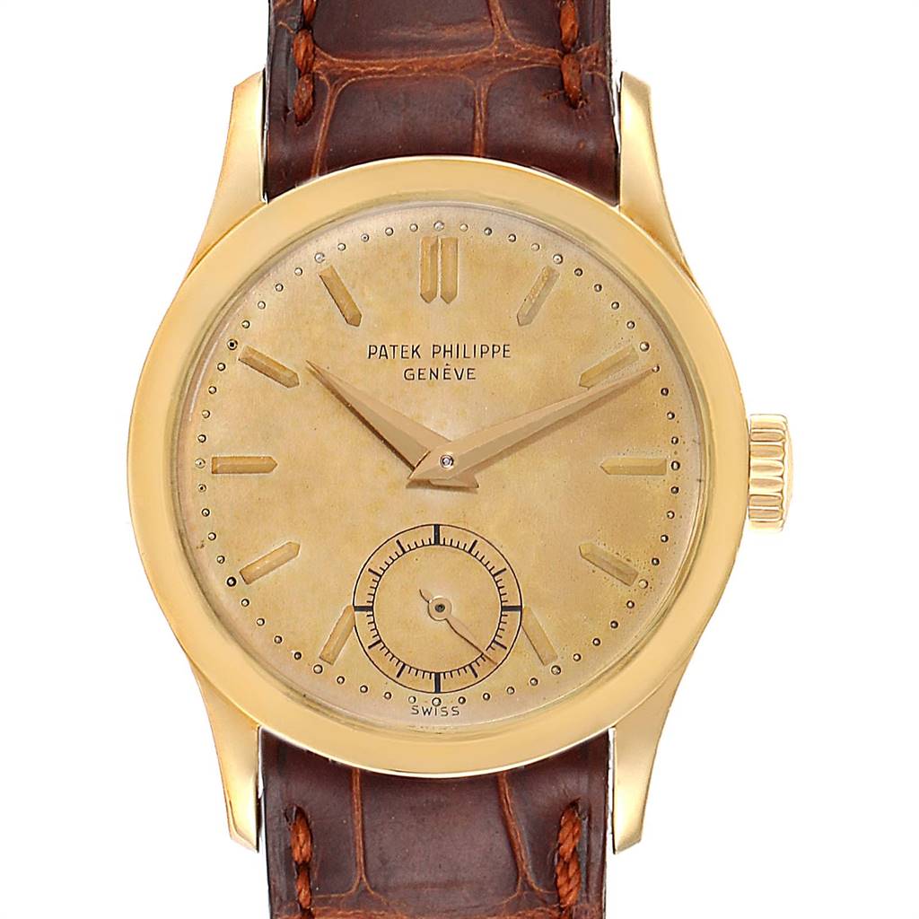 The image shows a front view of a vintage Patek Philippe watch with a gold case and a brown leather strap.