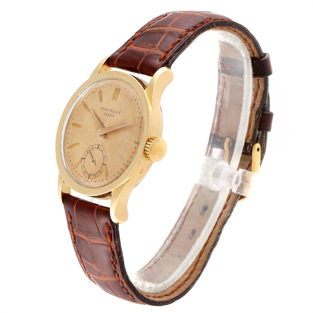 This image shows a Vintage Patek Philippe watch at a three-quarter angle, highlighting the face, case, crown, and leather strap.