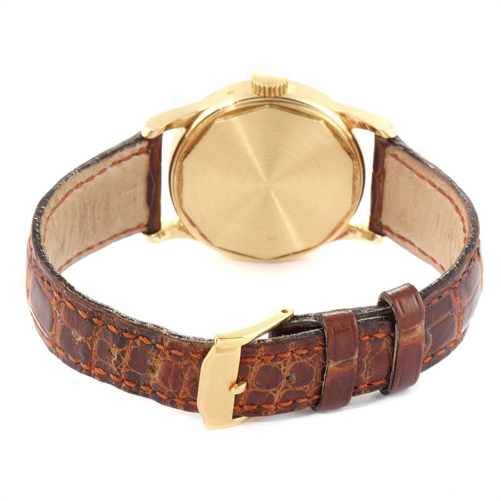 This image shows the back case and leather strap with a gold buckle of a Vintage Patek Philippe watch.