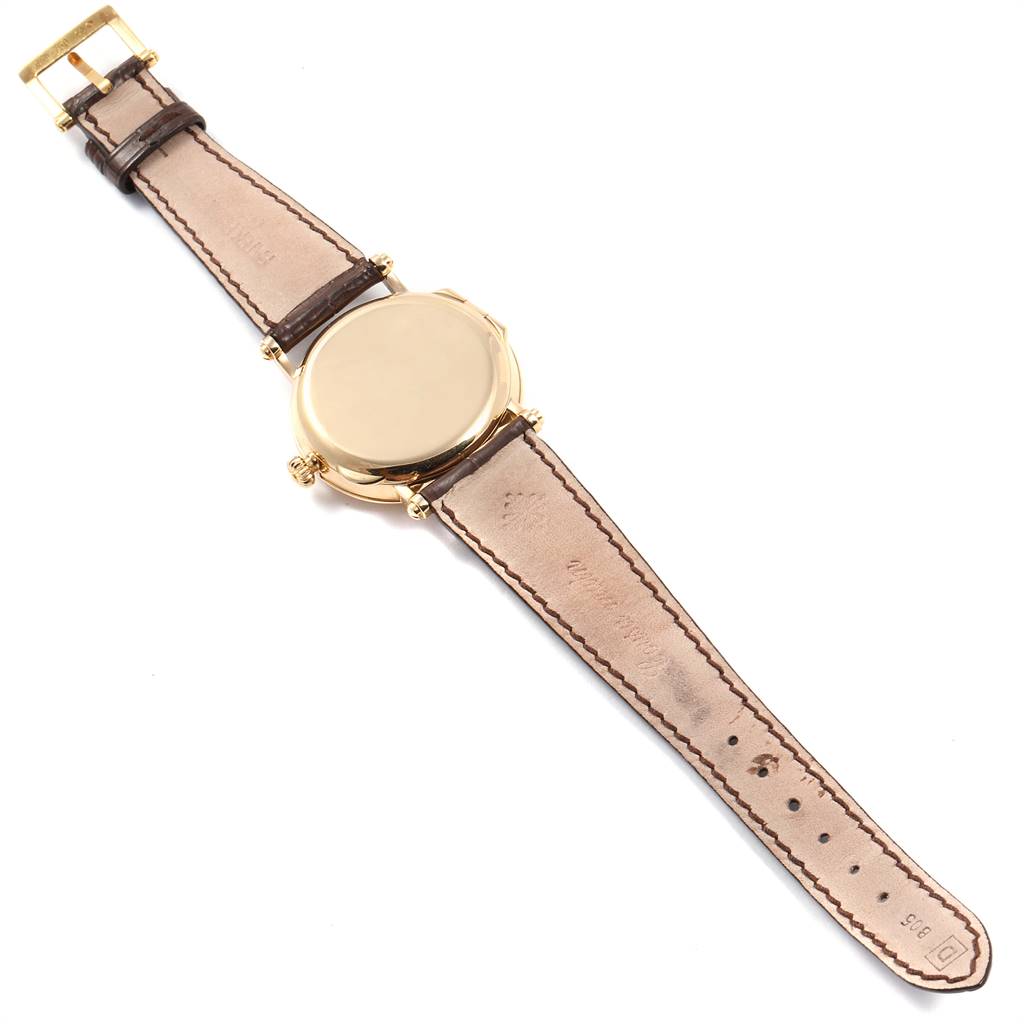 The image shows the back view of a Patek Philippe Calatrava 5053 Men
s Yellow Gold Beige Dial 5053 Men
s Yellow Gold Beige Dial watch, displaying the case back and leather strap.