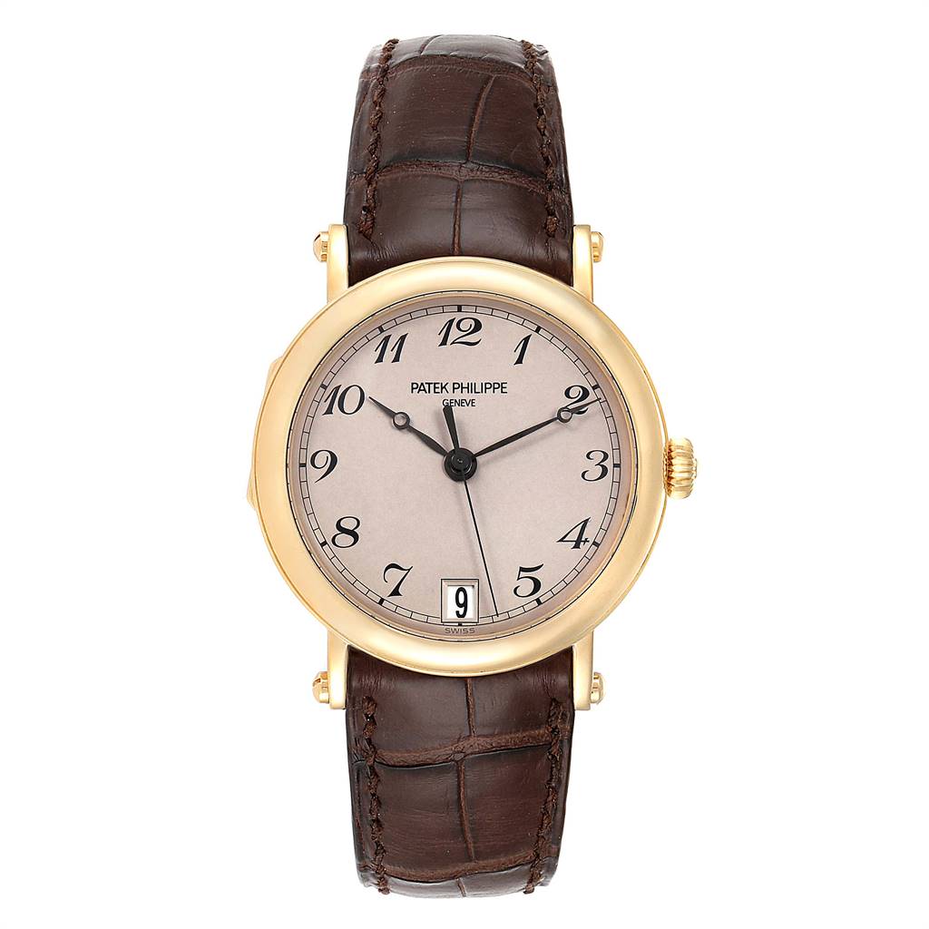 The image shows a front view of a Patek Philippe Calatrava 5053 Men
s Yellow Gold Beige Dial 5053 Men
s Yellow Gold Beige Dial watch featuring a gold case, brown leather strap, and analog dial with date display.