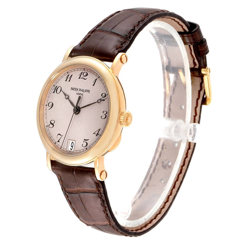 This image shows a gold Patek Philippe Calatrava 5053 Men
s Yellow Gold Beige Dial 5053 Men
s Yellow Gold Beige Dial watch at a slight angle, displaying the dial, crown, case, and leather strap.