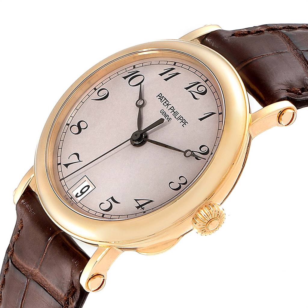 This image shows a close-up side angle of a Patek Philippe Calatrava 5053 Men
s Yellow Gold Beige Dial 5053 Men
s Yellow Gold Beige Dial watch, highlighting the dial, case, crown, and strap.