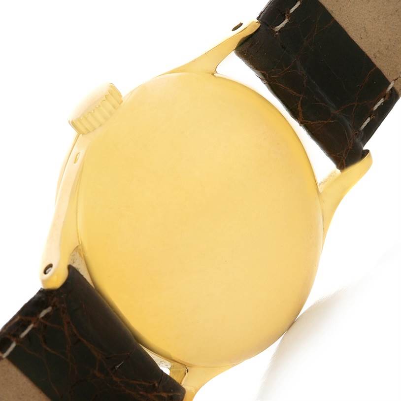 This image shows the back case and part of the strap of a Vintage Patek Philippe watch from a side angle.