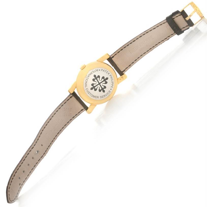 The image shows the back of a Patek Philippe Vintage model watch, highlighting the case back and leather strap.