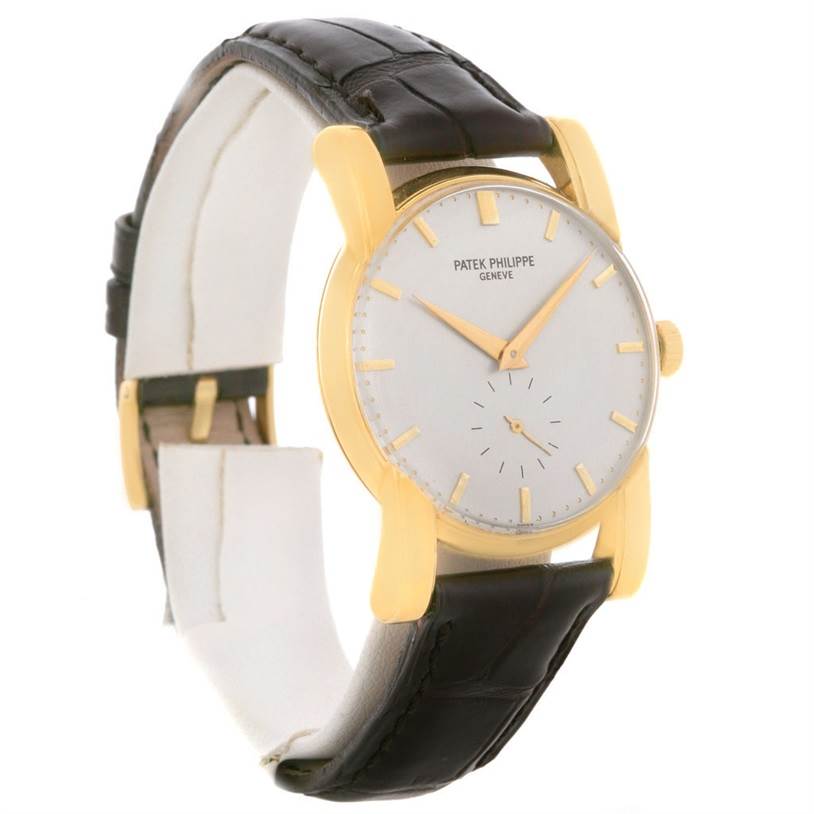 The image shows a side angle of a Vintage Patek Philippe watch, displaying its gold case, white dial, and black leather strap.
