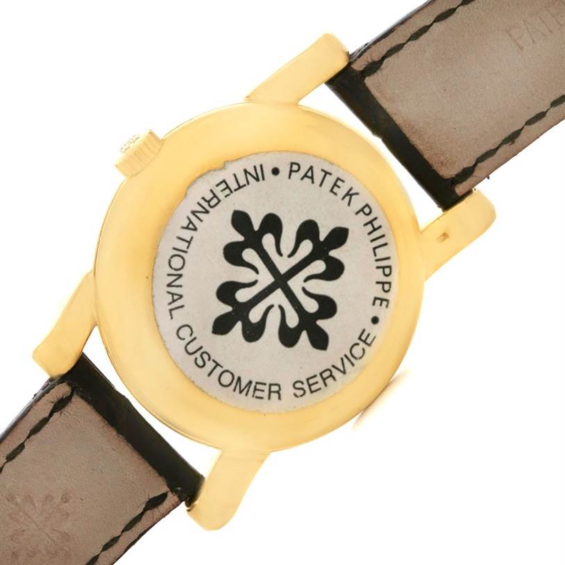 This image shows the back of a Vintage Patek Philippe watch with leather straps attached.