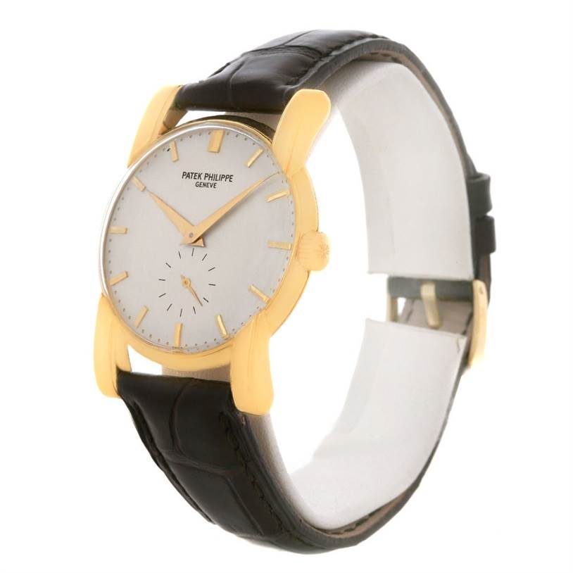 This image shows a side and front angle of the Vintage Patek Philippe watch, highlighting its gold casing and black leather strap.