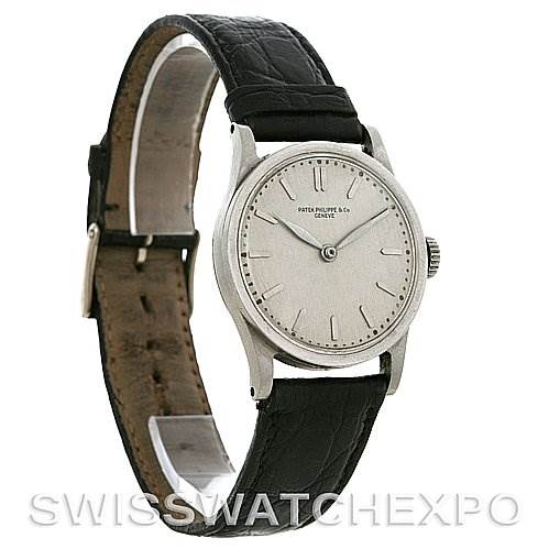 The image shows a side angle of a Vintage Patek Philippe watch, highlighting its face, bezel, crown, and black leather strap.