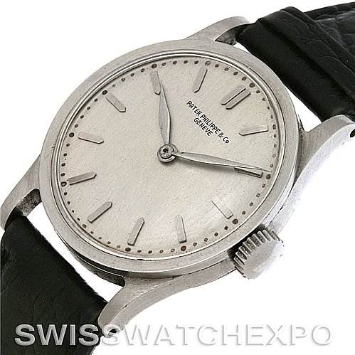 The image shows a Patek Philippe Vintage watch from an overhead angle, highlighting the dial, hands, and crown.
