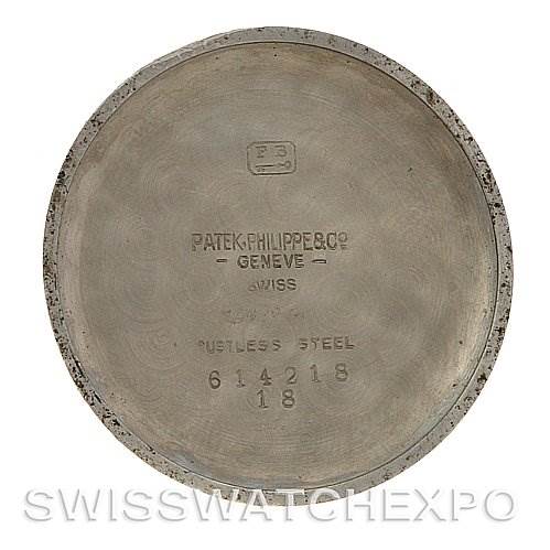 This image shows the inside case back of a vintage Patek Philippe watch, displaying the brand name, model number, and material.