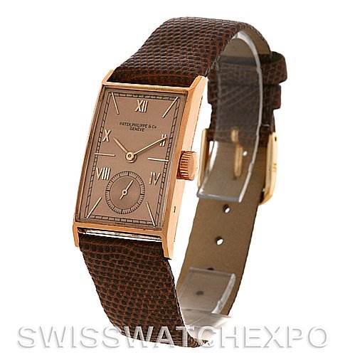 This image shows a Vintage Patek Philippe watch angled from the front, highlighting the face, case, and leather strap.