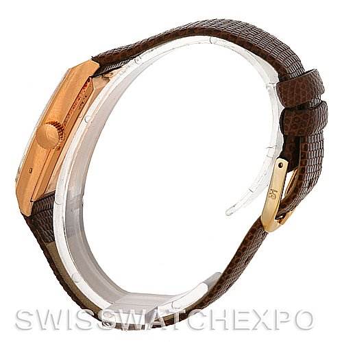 The image shows a side view of a Vintage Patek Philippe watch, highlighting its case, crown, and brown leather strap.