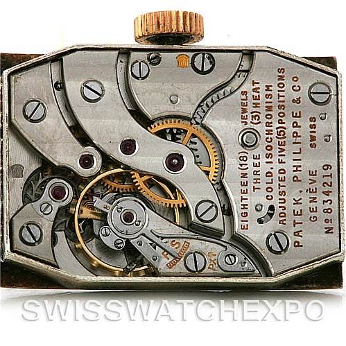 This image shows the open caseback of a Vintage Patek Philippe watch, revealing its intricate mechanical movement parts.