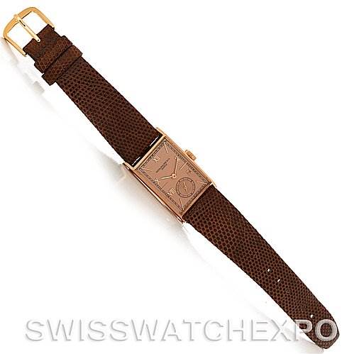 The image shows a top-down view of a Vintage Patek Philippe watch with a rectangular dial and brown leather strap.