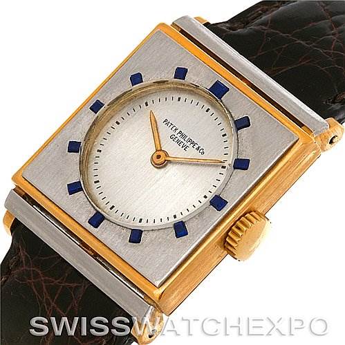 This image shows a vintage Patek Philippe watch from an angled top view highlighting the watch face, crown, and part of the leather strap.