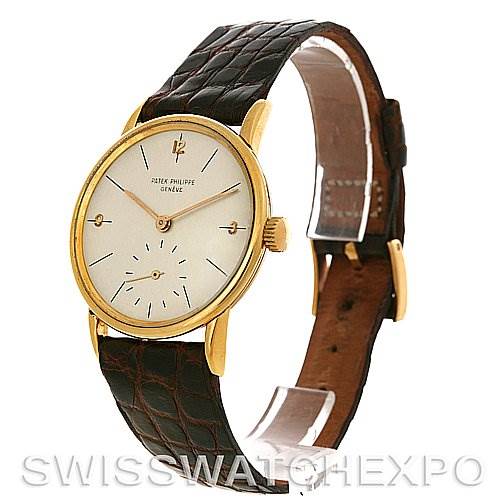 This image shows a Vintage Patek Philippe watch at a three-quarter angle, displaying its dial, case, crown, and leather strap.