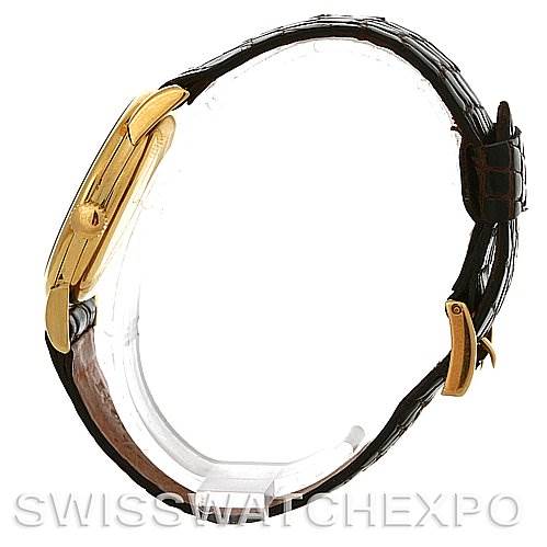 The image shows a side view of a Vintage Patek Philippe watch, highlighting its gold case and black leather strap.