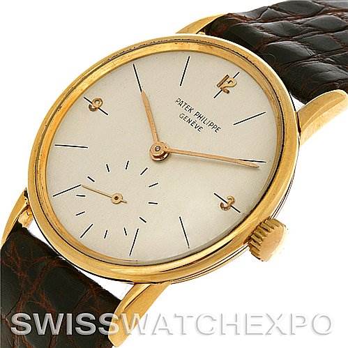 The image shows a Vintage Patek Philippe watch from an angle highlighting its face, gold case, and brown leather band.
