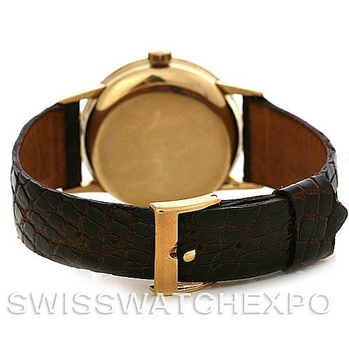 This image shows the back of a Vintage Patek Philippe watch, highlighting its leather strap and gold-tone buckle.