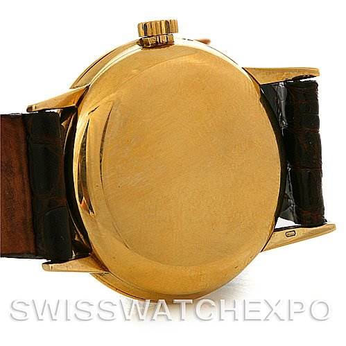 The image shows the back case, crown, and part of the leather strap of a Vintage Patek Philippe watch.