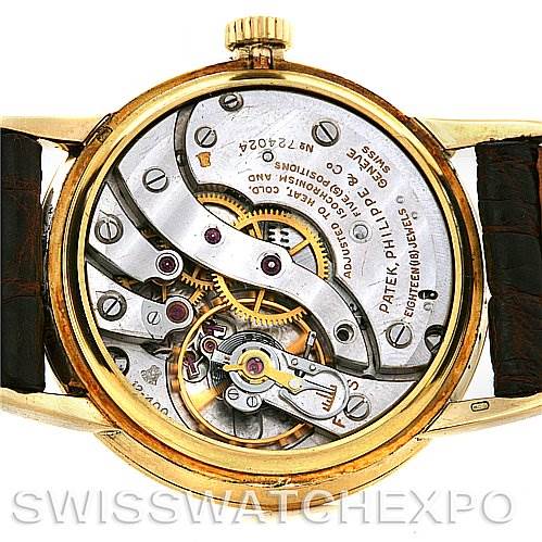 The image shows the intricate movement and internal mechanics of a Vintage Patek Philippe watch.