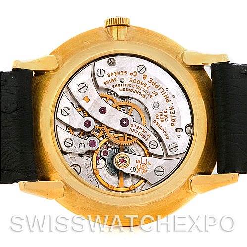 The image shows the back view of a Vintage Patek Philippe watch, revealing its intricate movement and mechanism.
