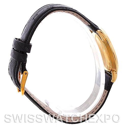 The image shows a side view of a Vintage Patek Philippe watch, highlighting the black leather strap and the yellow gold case.