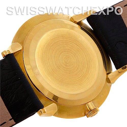 This image shows the back case of a Vintage Patek Philippe watch with a gold finish and black leather straps.
