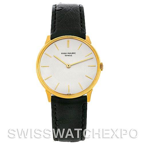 This image shows a front view of the Patek Philippe Vintage watch with a gold case, white dial, and black leather strap.