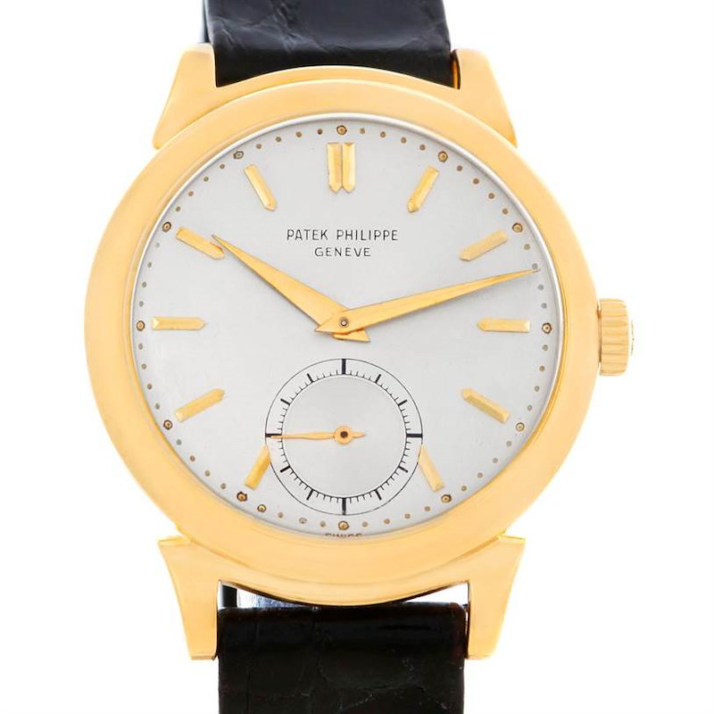 This image shows a Patek Philippe Vintage model watch from the front, featuring a gold case, white dial, gold markers, and a black leather strap.