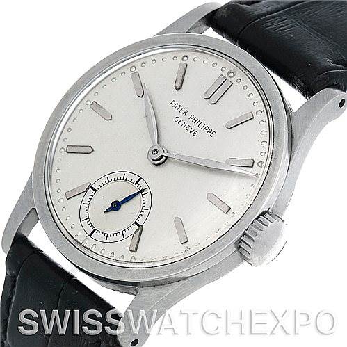 This image shows a Patek Philippe Vintage watch from a slight angled close-up of its face, crown, and part of the leather strap.