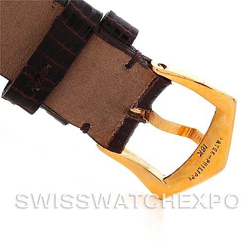The image shows a close-up of the gold buckle of a Patek Philippe Vintage watch, attached to a leather strap.