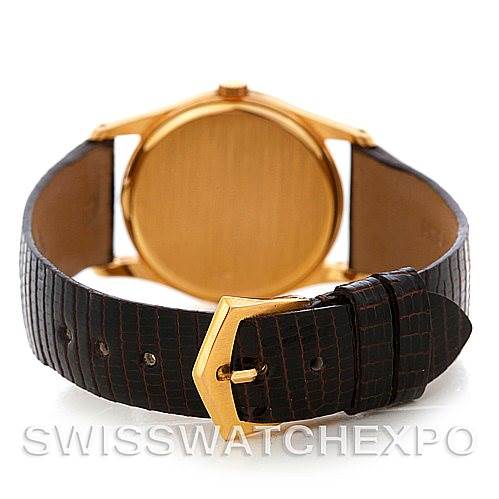 The image shows the back view of a Vintage Patek Philippe watch, focusing on the gold case back and leather strap with buckle.