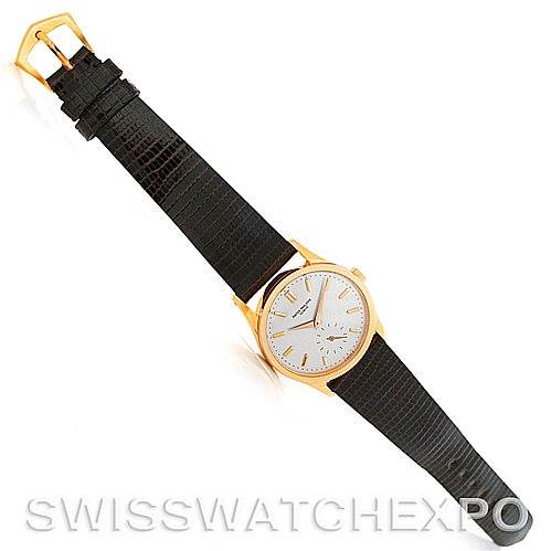 This image shows a top-down view of a Vintage Patek Philippe watch, highlighting its dial, case, and black leather strap.