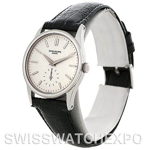 This image shows a side view of a Vintage Patek Philippe watch, highlighting its dial, hands, crown, and black leather strap.