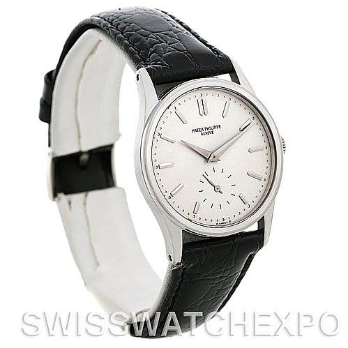 This image shows a side angle of a Vintage Patek Philippe watch, displaying its round dial, black leather strap, and silver casing.
