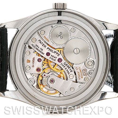The image shows the back case view of a Vintage Patek Philippe watch, revealing its intricate movement and mechanism.