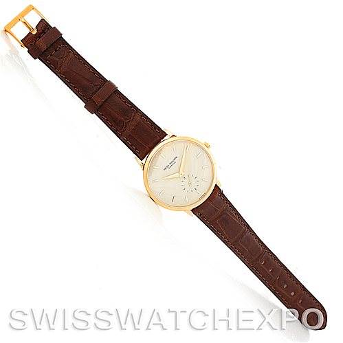 The image shows a Patek Philippe Vintage 3893 Men's Yellow Gold Champagne Dial 3893 Men's Yellow Gold Champagne Dial watch from a top-down angle, displaying its brown leather strap and gold case.