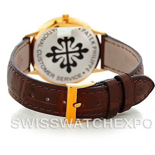 The image shows the back view of a Vintage Patek Philippe watch, showcasing its leather strap and case back with branding.