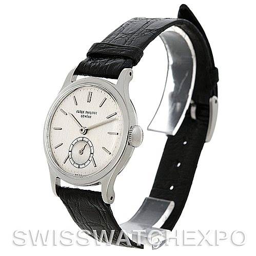 The image shows a side view of a Vintage Patek Philippe watch, displaying its face, crown, and black leather strap.