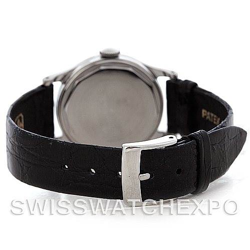 The image shows the back view of a Vintage Patek Philippe watch, highlighting its black leather strap and polished case back.