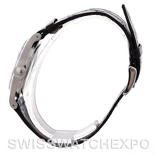 Side angle view of a vintage Patek Philippe watch, showing the case, crown, and leather strap.