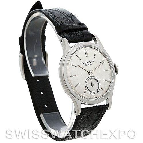 The image shows a side angle view of a Vintage Patek Philippe watch, featuring its face, bezel, case, and black leather strap.