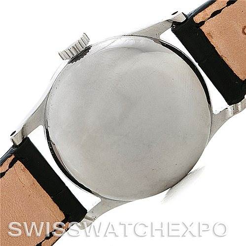 This image shows the back case and part of the leather strap of a Vintage Patek Philippe watch.