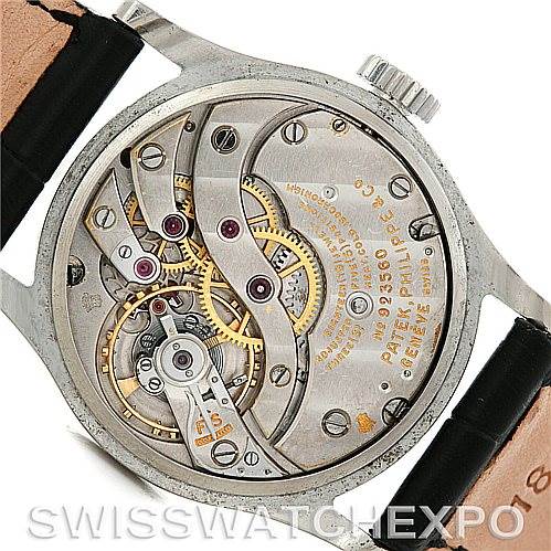 The image shows the exposed mechanical movement of a Vintage Patek Philippe watch, viewed from the back.