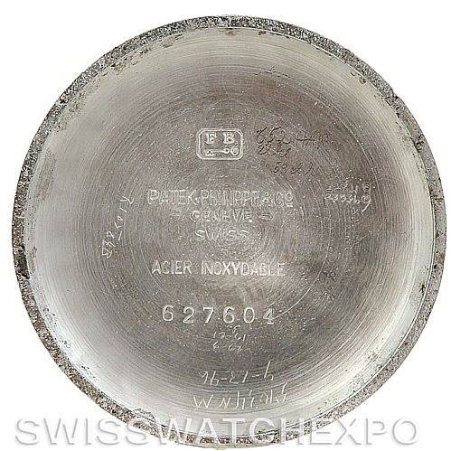 The image shows the interior of the case back of a Vintage Patek Philippe watch, including brand engravings and serial numbers.