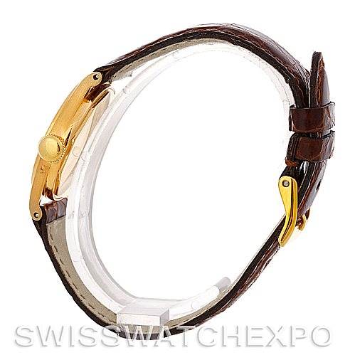 This side view of the Patek Philippe Vintage 437 Men's Yellow Gold Silver Dial 437 Men's Yellow Gold Silver Dial watch shows its case, crown, and leather strap with a clasp.