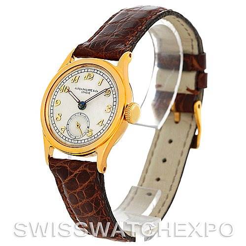 The image shows a side view of the Vintage Patek Philippe watch, highlighting its brown leather strap, gold case, and dial.