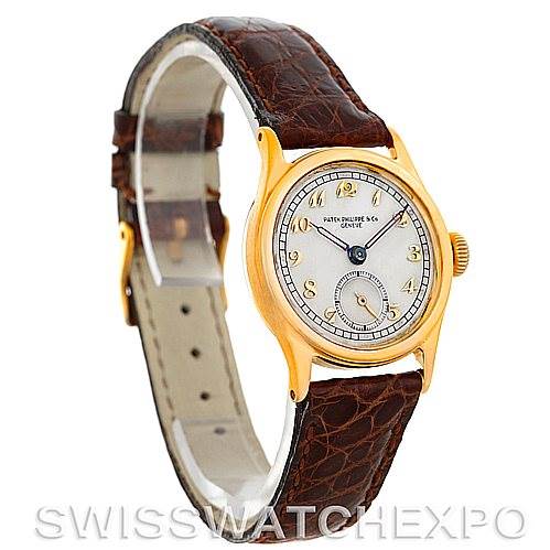 This image shows a side angle of a Vintage Patek Philippe watch, highlighting the face, leather strap, and gold casing.